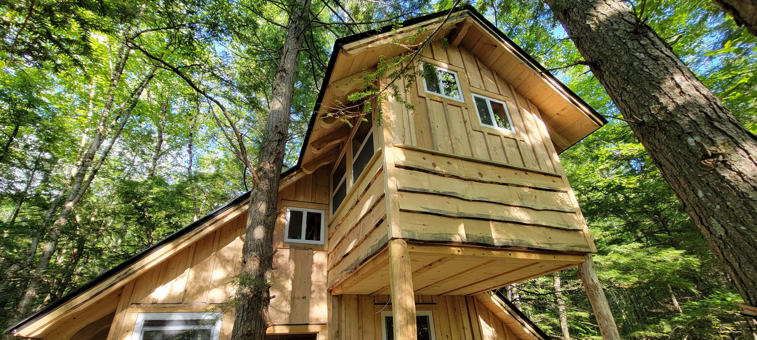This cozy treehouse sleeping loft creates a covered deck space below.